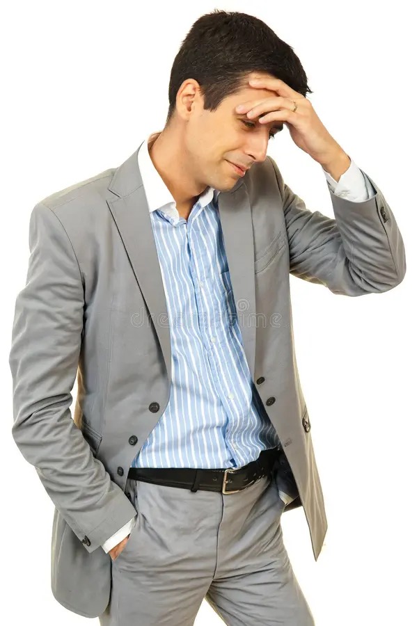 Stressed businessman with his head in his hand
